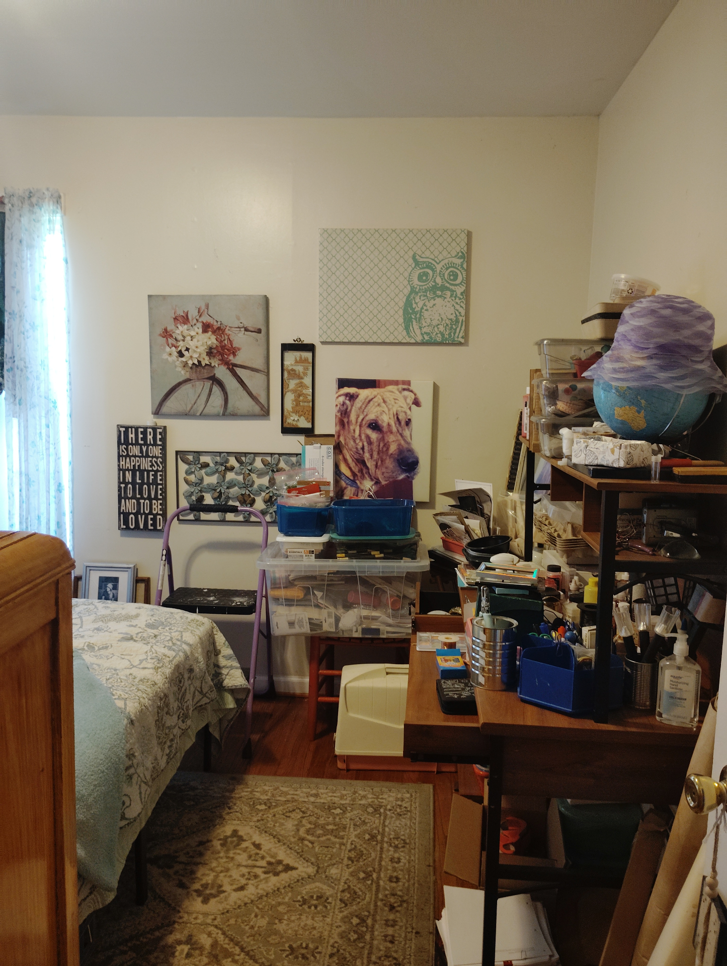 A wider view of Weston's bedroom at the Cat Nap Inn with art on the wall, a desk, and the room arranged for making and resting
